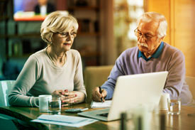 Elderly couple participating in an online class